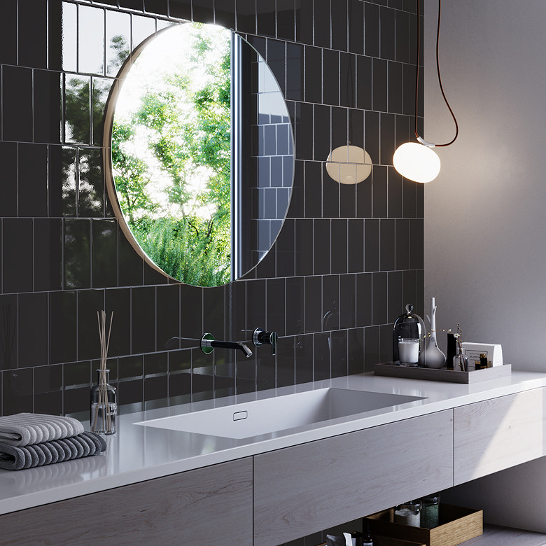Glossy dark grey vertical subway tiles behind a modern bathroom vanity with a round mirror.