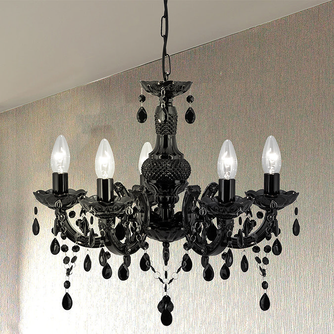 Elegant black chandelier featuring intricate detailing, cascading crystal-style droplets, and five candle-style lights, adding a dramatic and luxurious touch to the room.