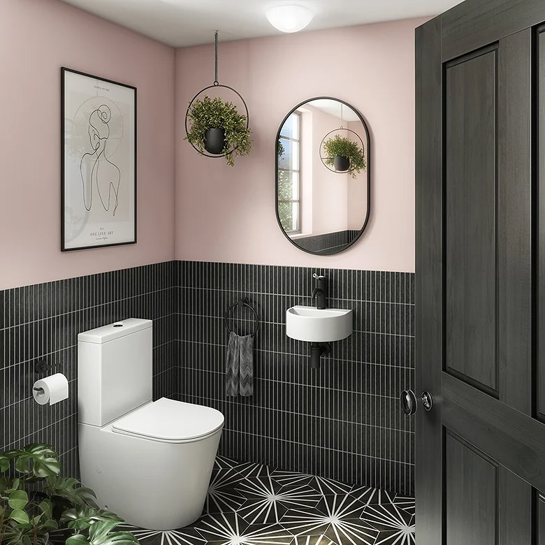 Half tiled bathroom with dark kit kat tiles at half height and soft painted walls above