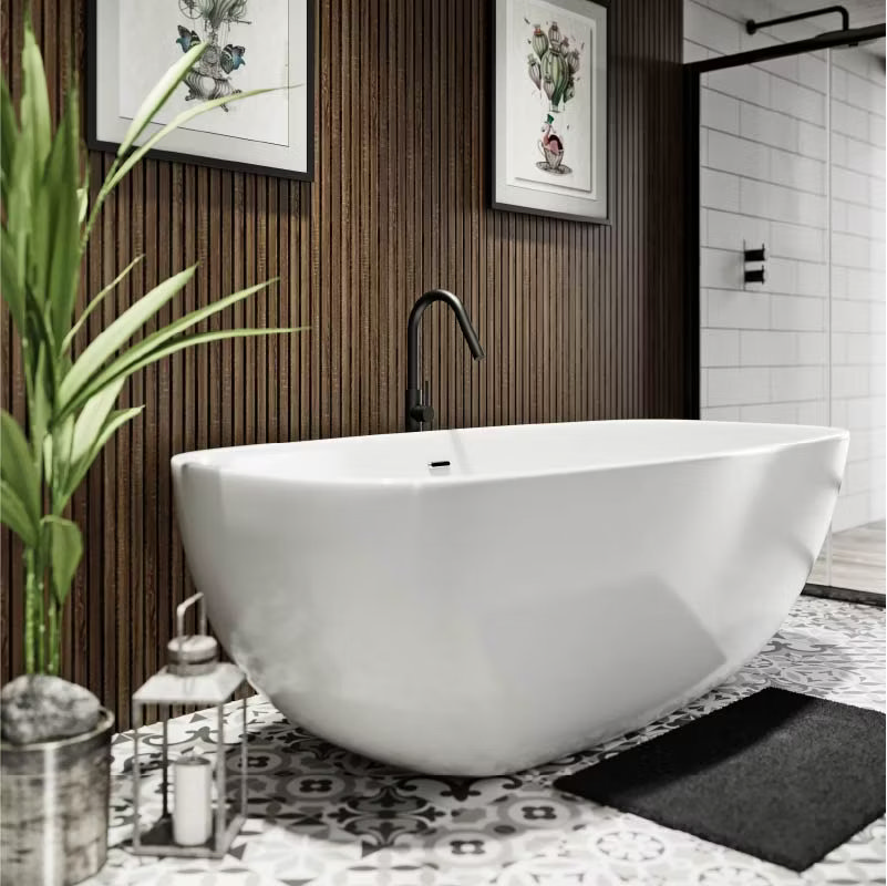 Freestanding white bathtub with black tap set against a wood-panelled feature wall, complemented by patterned encaustic floor tiles and greenery, creating a soft industrial bathroom look.