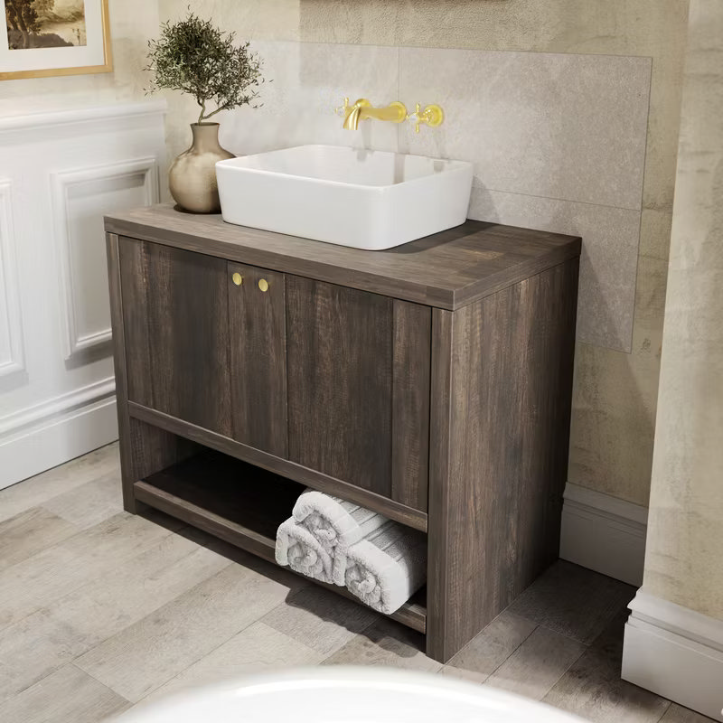 Rustic wood vanity unit with a countertop basin and brushed gold taps, creating a refined and minimalist look in this Quiet Luxury bathroom.