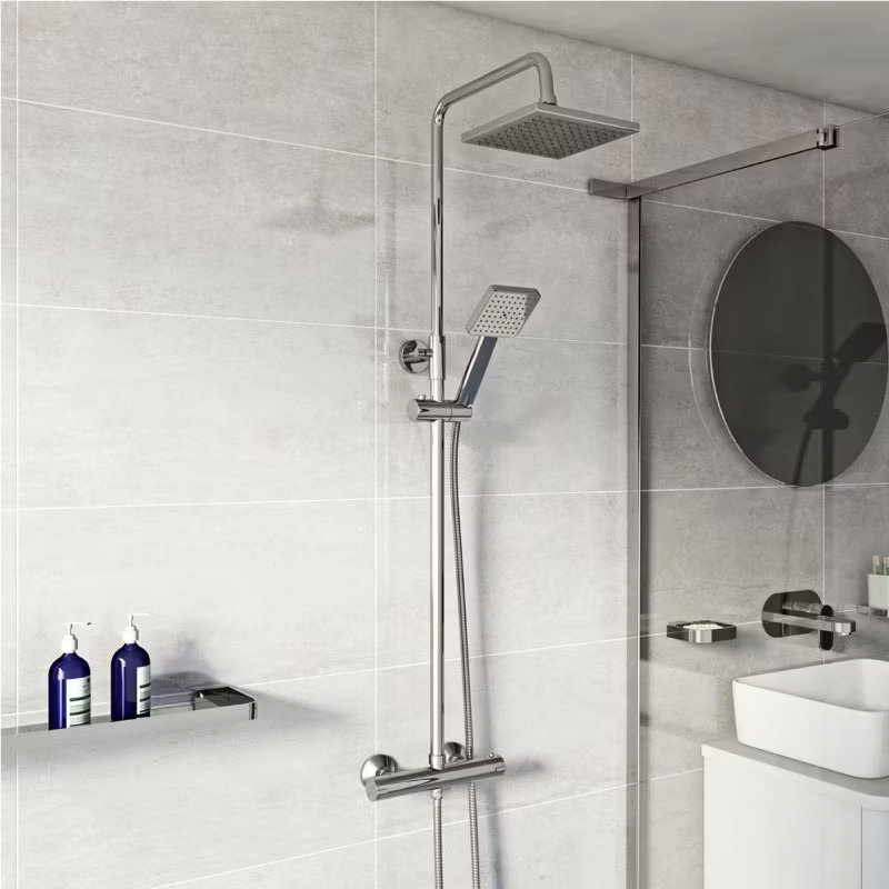 Modern dual shower system with a square rainfall head and adjustable handheld shower against grey tiled wall