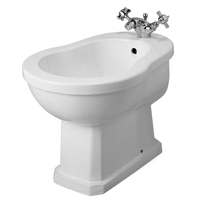 Traditional white ceramic bidet with chrome crosshead taps