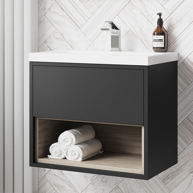 Wall-hung black bathroom vanity unit with open shelf storing rolled towels