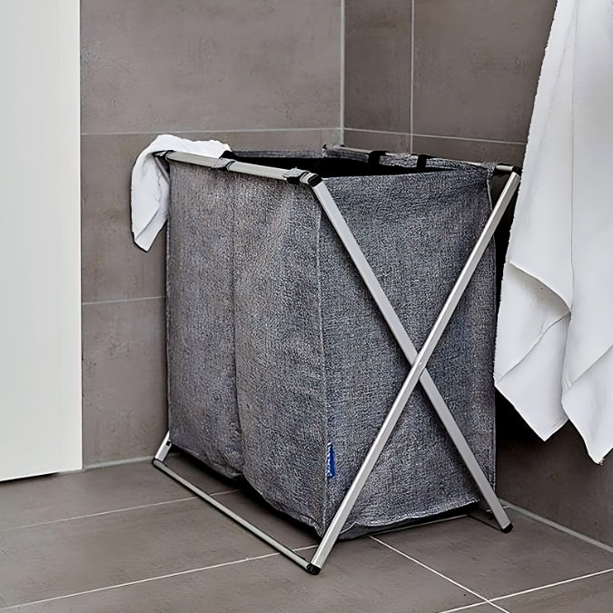 Grey fabric laundry basket with folding metal frame in bathroom