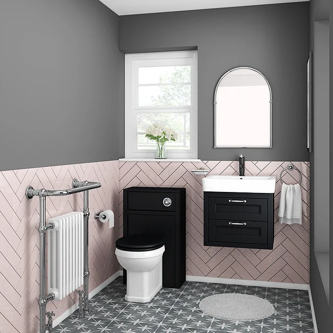 Contemporary bathroom with black vanity, pink herringbone tiles, and patterned floor