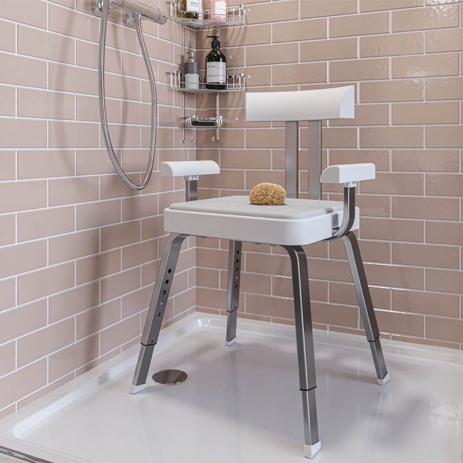 Adjustable shower chair with backrest and armrests in tiled bathroom