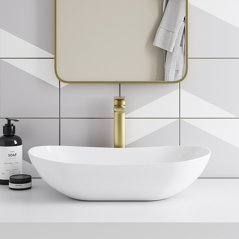 Modern bathroom sink with white countertop basin and brushed brass tap