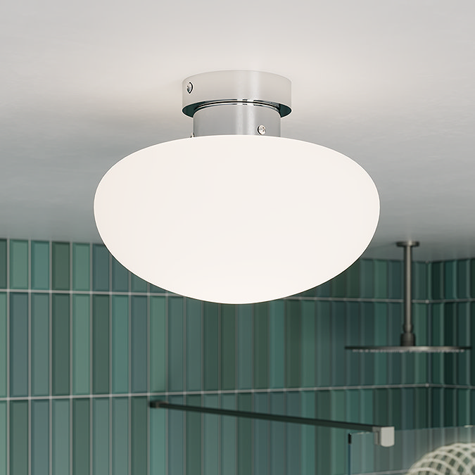 Modern bathroom ceiling light with a frosted glass shade and chrome fitting, complementing a green tiled shower area for a sleek, contemporary look.