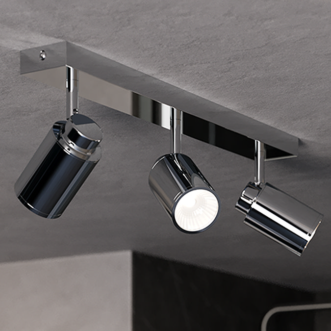 Modern chrome-finished triple spotlight fixture with adjustable heads, mounted on a sleek ceiling panel, perfect for contemporary bathroom lighting.