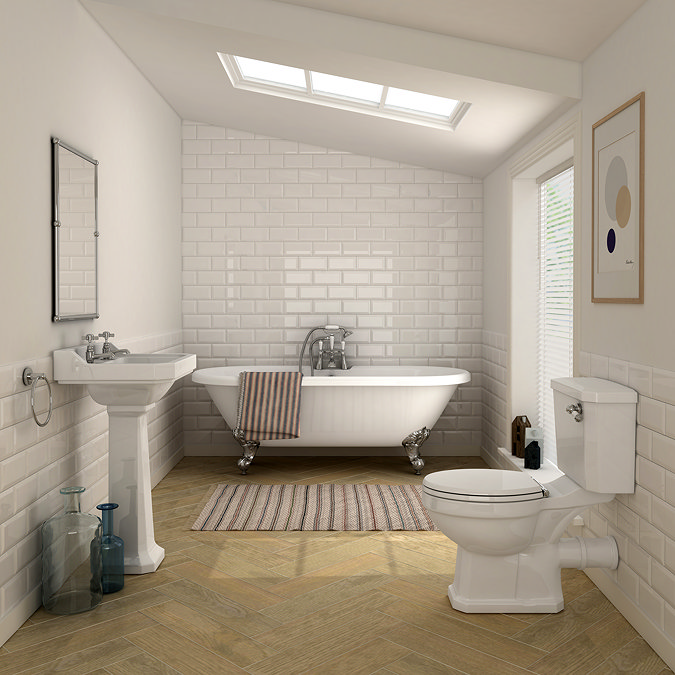 Small bathroom with glossy white metro wall tiles and herringbone wood-effect floor tiles, styled with a freestanding bath