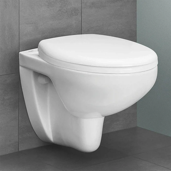 Minimalist Rimless Wall-Hung Toilet with a Sleek White Design Against Contemporary Grey Tiles.