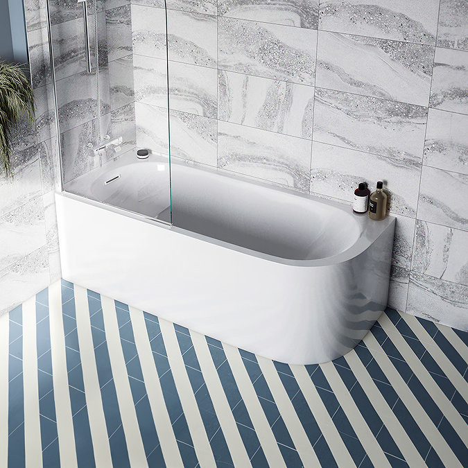 Modern bathroom with a white curved bathtub, glass shower screen, gray marble-effect wall tiles, and blue and white striped floor tiles.