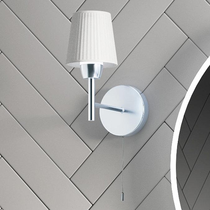 Modern bathroom wall light with a pleated white fabric shade and a chrome finish, featuring a convenient pull cord switch for ease of use.