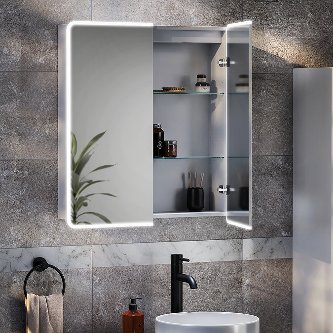 Modern LED bathroom mirror cabinet with glass shelves storing toiletries