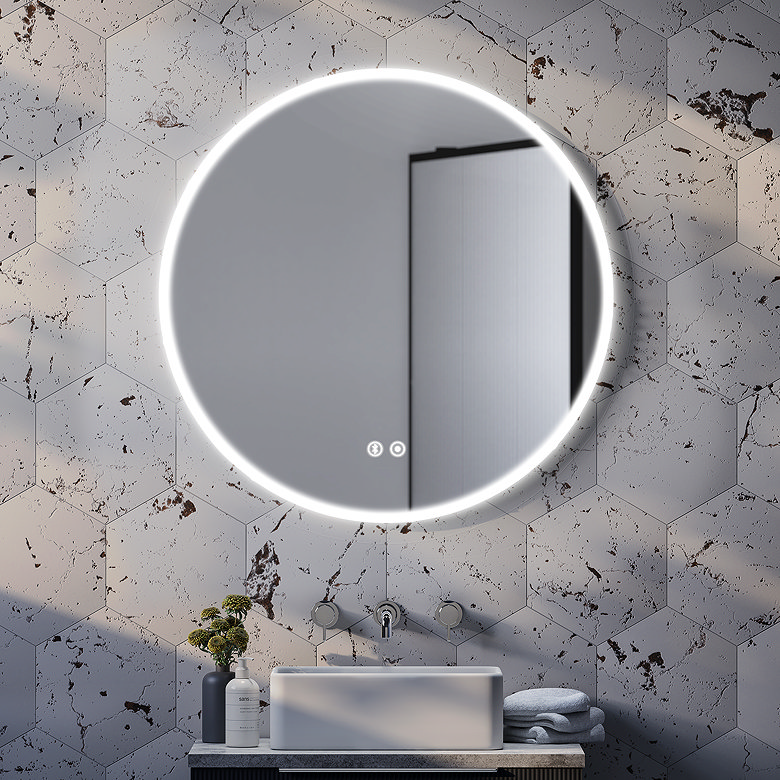 Round LED illuminated heated bathroom mirror with anti-fog demister above basin