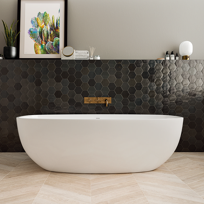 Freestanding white bath in front of glossy black hexagon tiled feature wall.