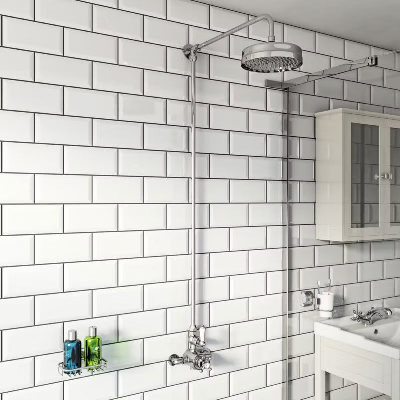 Traditional bathroom with exposed chrome shower pipe and white subway tiles for a classic look