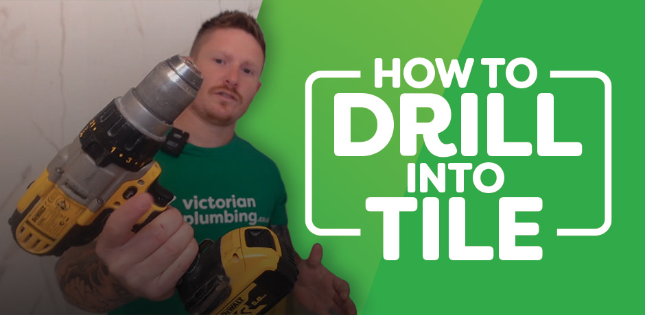 Victorian Plumbing guide cover image featuring a person holding a power drill, with the title 'How to Drill Into Tile' displayed in bold text.