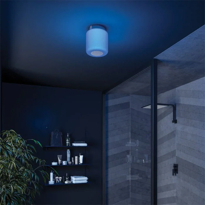 Modern bathroom with a blue-lit ceiling Bluetooth speaker light, sleek black shelving, and a walk-in shower with contemporary fixtures, creating a calming ambiance.