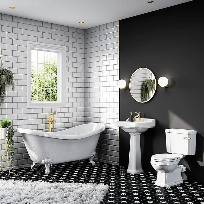 Elegant bathroom featuring round wall lights that illuminate a classic pedestal sink and gold fixtures. The soft lighting adds a warm glow, complementing the black feature wall and star-patterned floor tiles.