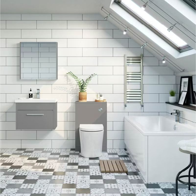 Bright and budget-friendly bathroom update featuring grey cabinets, patterned tile flooring, and white subway tiles under a skylight, showcasing affordable renovation ideas.