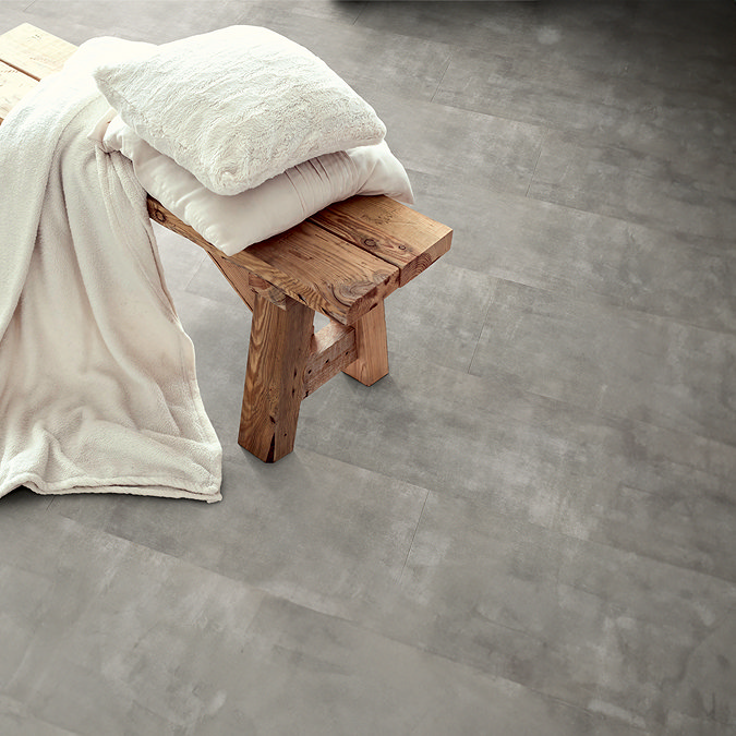 Cosy room with grey vinyl plank flooring, featuring a rustic wooden bench topped with a fluffy white pillow and soft blanket. Durable and stylish vinyl floor perfect for a warm, modern home design.