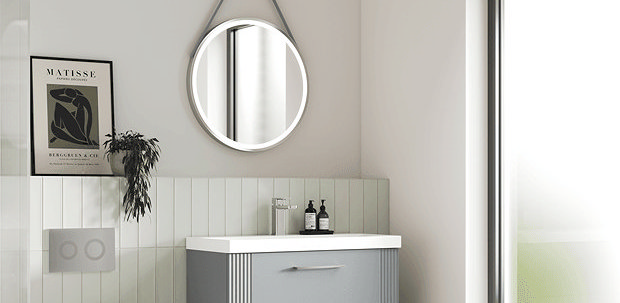 Modern Quiet Luxury bathroom featuring a wall-hung grey vanity unit, round mirror, and soft neutral tones. Minimalist design with sleek fixtures and large window providing natural light.