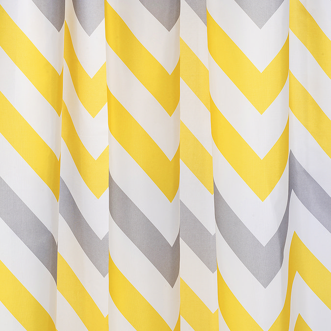 Yellow, grey, and white chevron-patterned shower curtain with bold diagonal stripes, adding a vibrant and modern touch to bathroom decor.