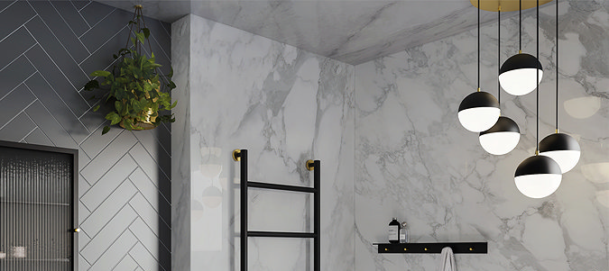 Modern bathroom with marble walls, black accents, and a statement cluster pendant ceiling light for stylish ambient lighting.