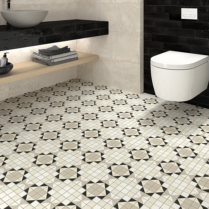 Modern bathroom with beige and black patterned floor tiles, floating wooden shelf, vessel sink, and wall-mounted toilet.