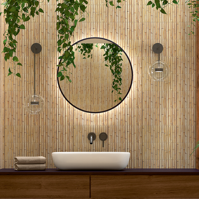 Modern bathroom with textured bamboo wall tiles, a round LED-backlit mirror, cascading green plants, and a white countertop basin on a wooden vanity.