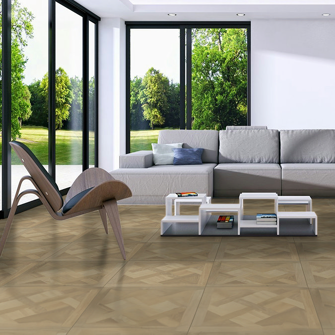 Modern living room with large windows offering a scenic view of greenery, featuring elegant light wood-effect tiles, a grey sectional sofa, and a minimalist coffee table. The flooring adds warmth and natural charm to the space.