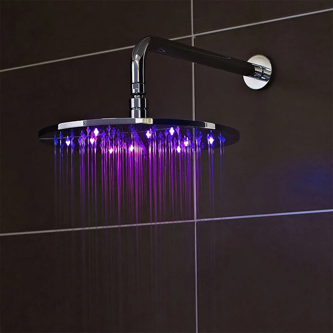 LED rainfall shower head with purple lighting against dark tiled bathroom wall – a bold, mood-enhancing feature for contemporary purple-themed bathrooms.