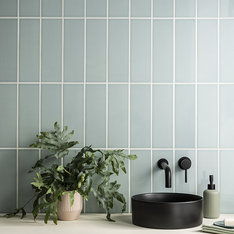 Vertical stack tile layout with soft green rectangular tiles creating modern bathroom wall tile design