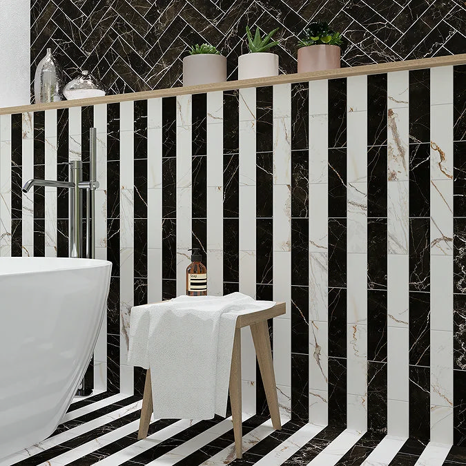 Stylish bathroom featuring black and white marble herringbone and vertical striped tiles with a freestanding tub, wooden stool, and decorative plant shelf, perfect for modern luxury interiors.