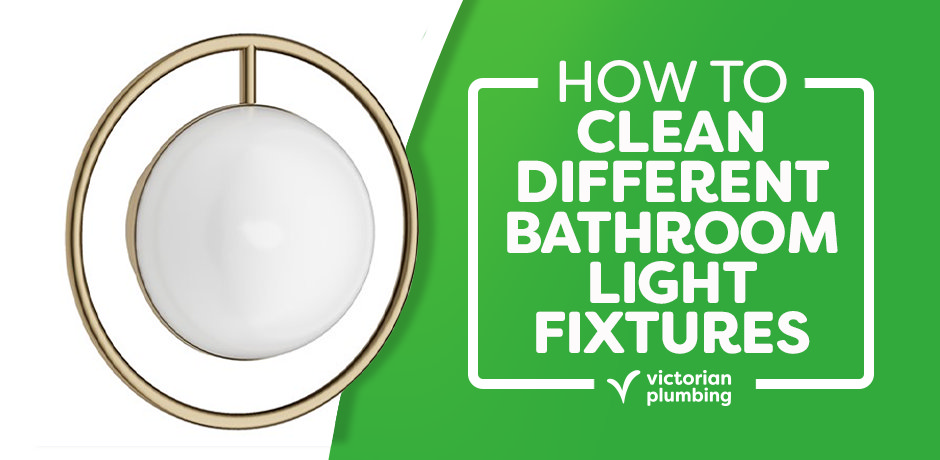 Modern bathroom wall light with a circular gold frame and white globe shade next to a green banner reading “How to Clean Different Bathroom Light Fixtures” by Victorian Plumbing.