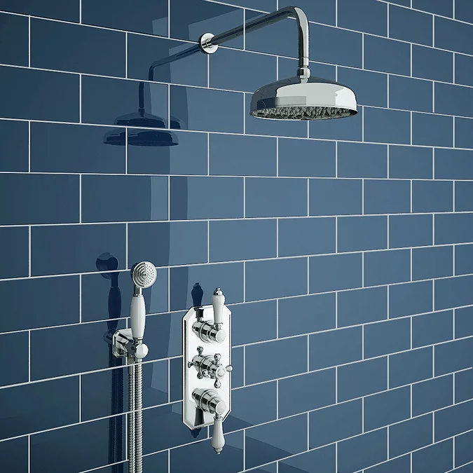 Traditional chrome mixer shower with rainfall showerhead and handheld option against classic blue subway tiles. Perfect for consistent water flow and luxurious showering experience.