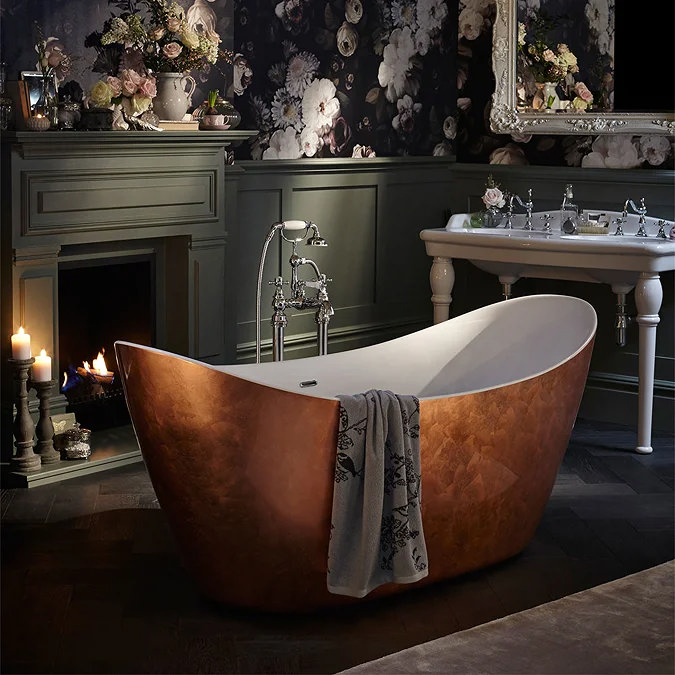 Luxurious rustic bathroom with copper freestanding bath, floral wallpaper, and fireplace