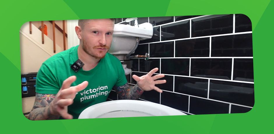 DIY Expert Explaining Close Coupled Toilet Installation Steps in Front of a Newly Installed Unit.