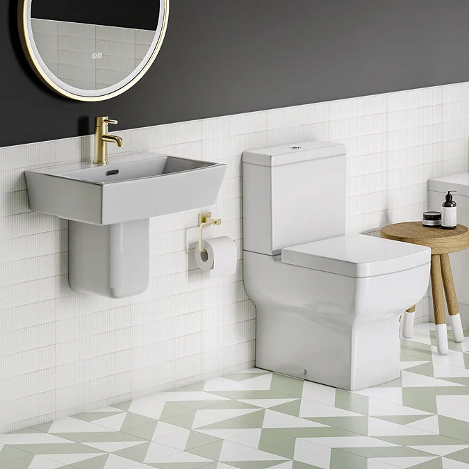 Modern cloakroom with square semi-pedestal basin and close-coupled toilet against white tiled wall.