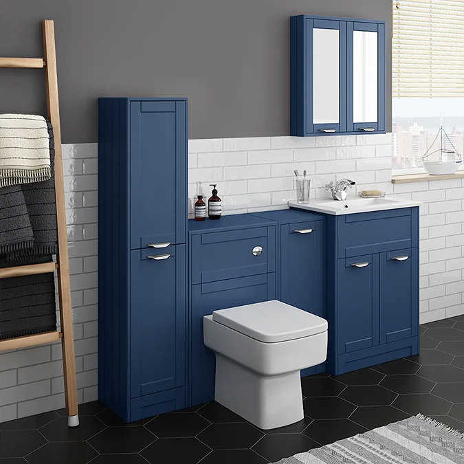 Modern bathroom with blue fitted cabinets, white metro tiles, and black hexagonal floor tiles