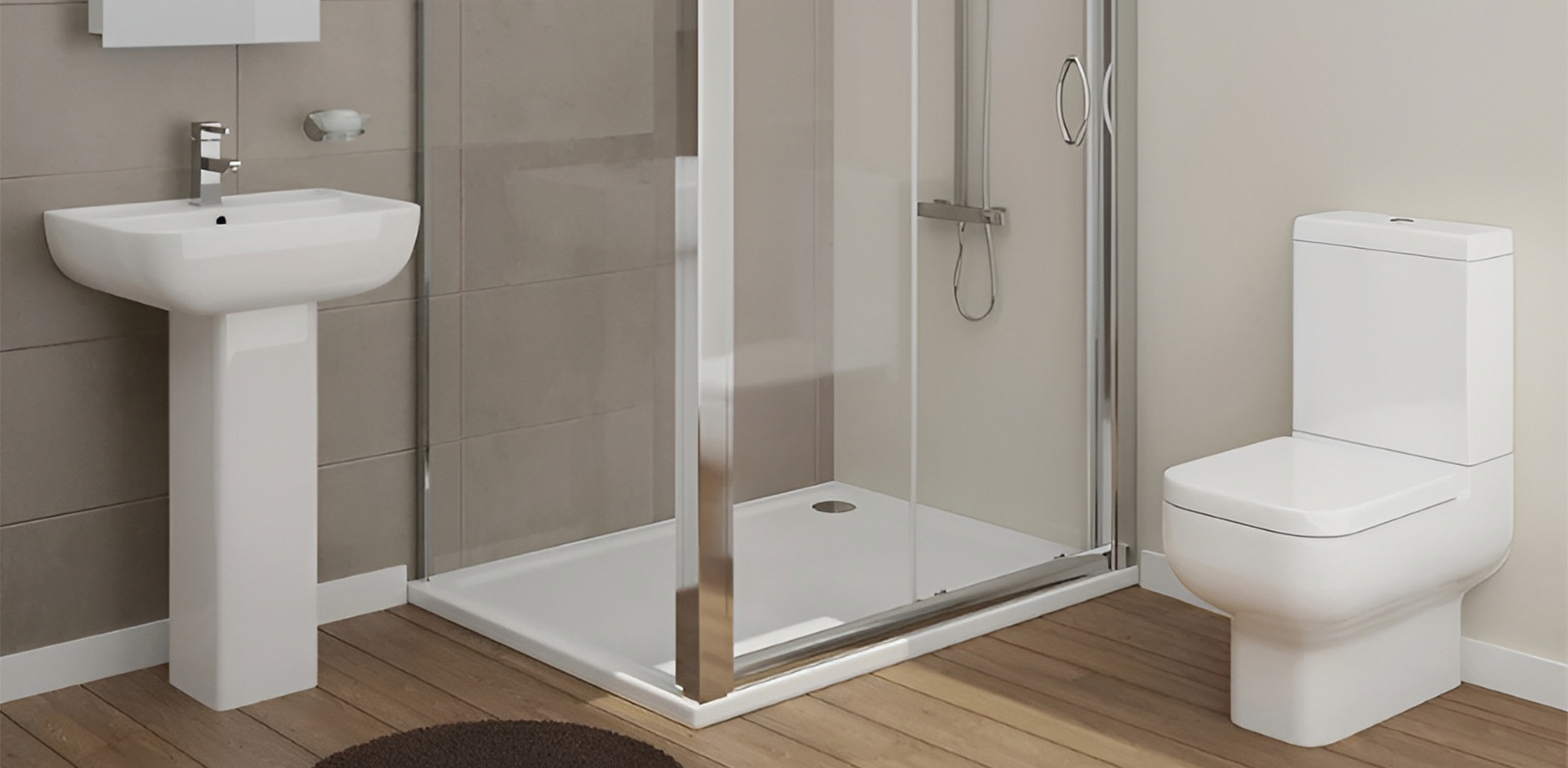 Modern ensuite bathroom with a spacious shower enclosure, pedestal sink, and close-coupled toilet, featuring neutral tones and wood-effect flooring.