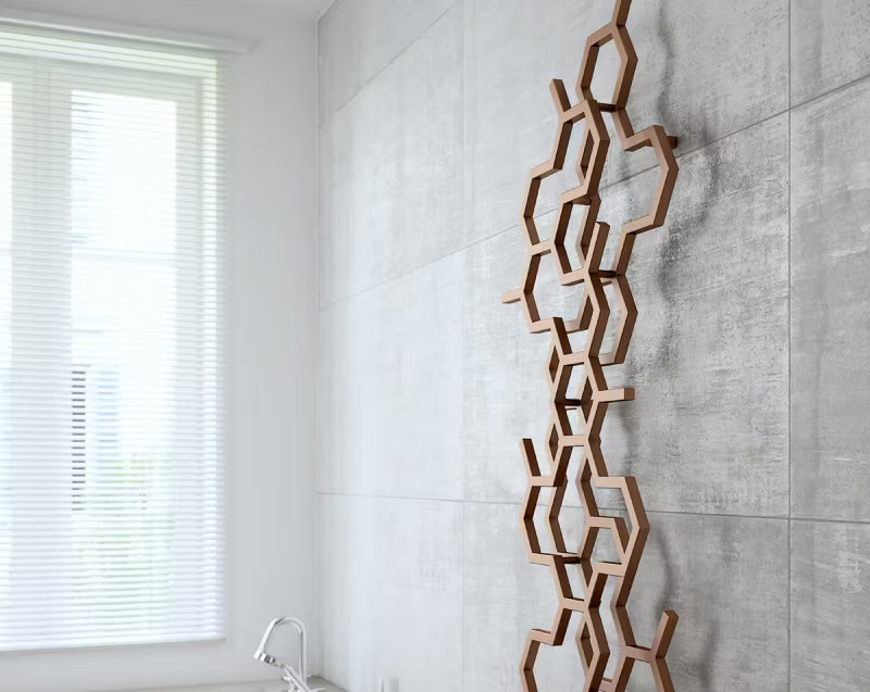 Modern bathroom with unique hexagonal wooden radiator on light grey tiled wall