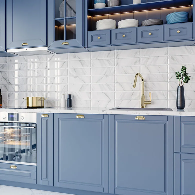 White marble effect kitchen tiles with blue cabinets.