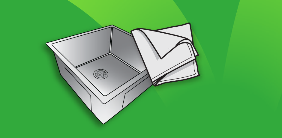 Drying a stainless steel sink with a cloth after rinsing with warm water