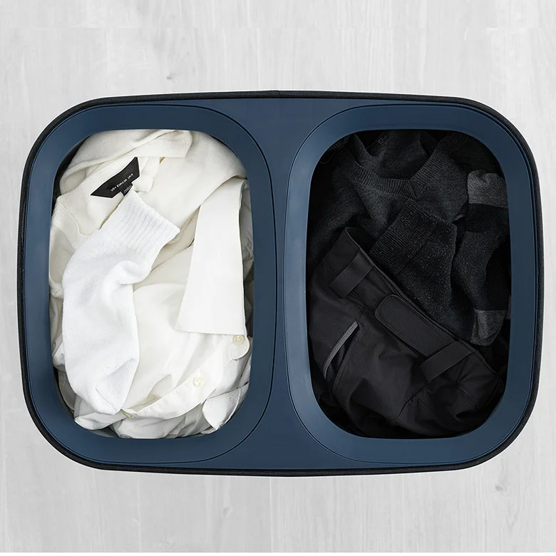 Laundry basket with light and dark clothes sorted ready for washing