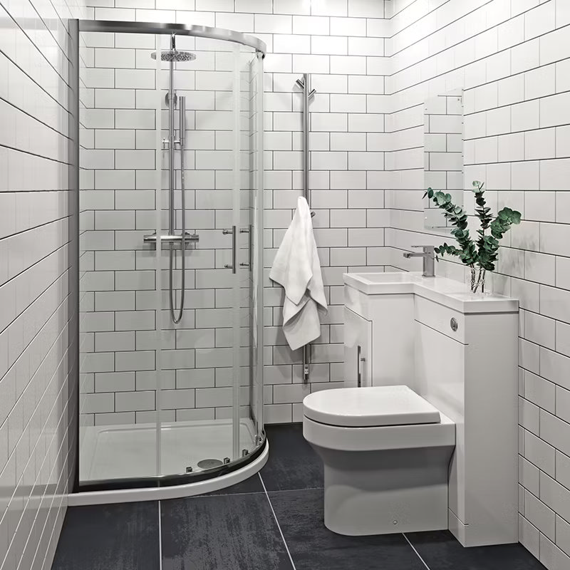 Modern ensuite bathroom with white metro tiles, quadrant shower enclosure, and back-to-wall toilet, featuring a compact vanity unit and chrome towel radiator.