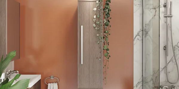 Cost-effective bathroom renovation with warm orange walls, wooden cabinetry, and modern bath featuring marble wall panels, showing affordable ways to update your bathroom decor.