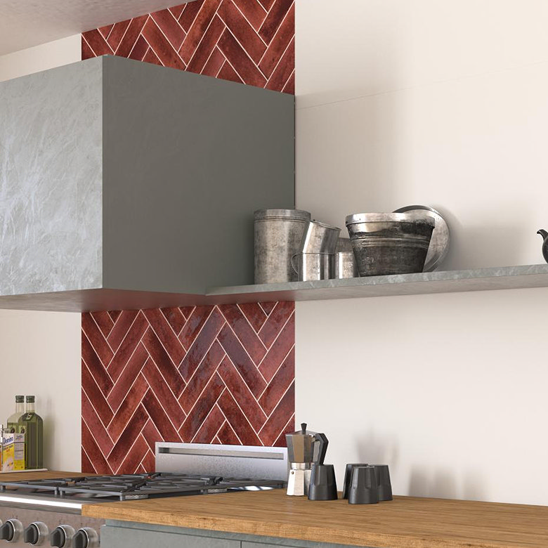 Red herringbone tiles used as kitchen splashback.